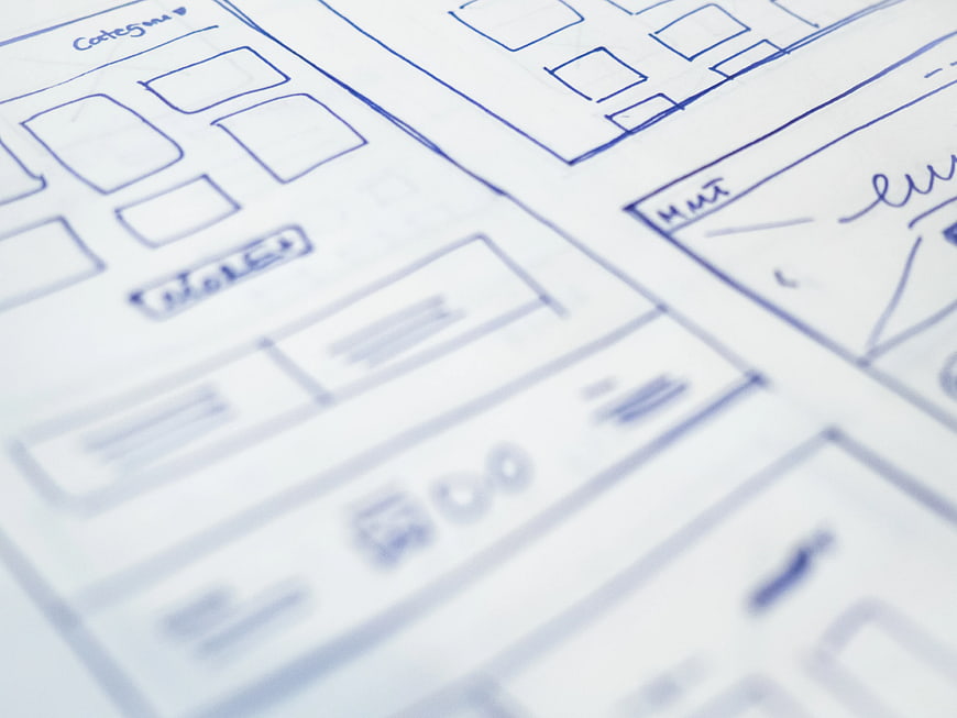 Hand-drawn website wireframe sketches on paper