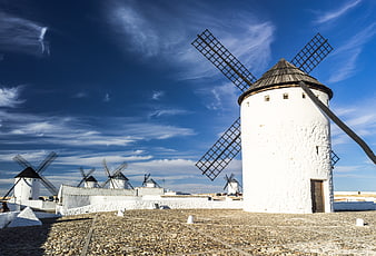 Traditional White Windmills in La Mancha Under Blue Sky