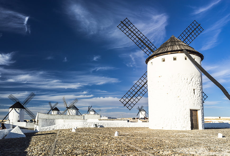 Traditional White Windmills in La Mancha Under Blue Sky