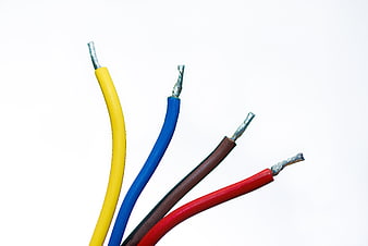Colorful electrical wires with exposed copper tips on white background