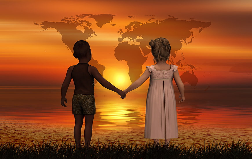 Children holding hands watching world map sunset