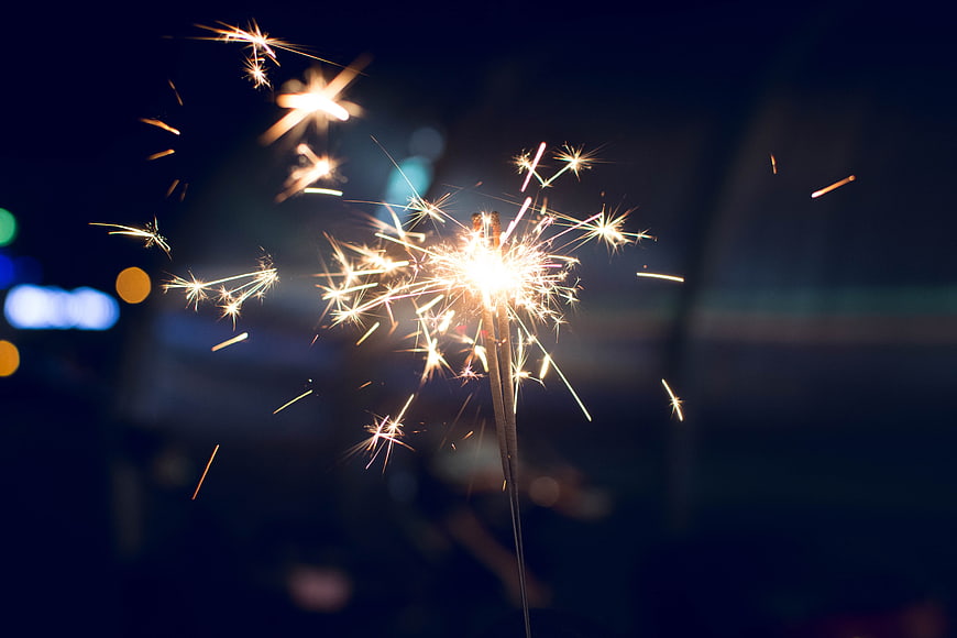 Sparkler Burning Brightly Against Dark Night Sky Background