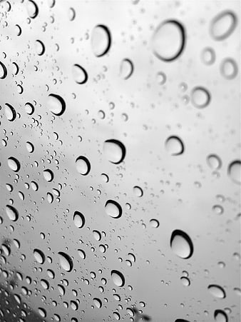 Black and white raindrops on glass window texture