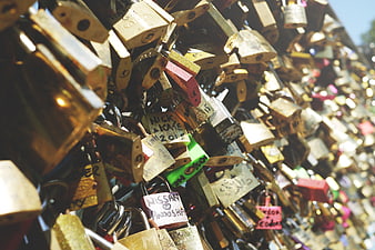 Close-up of colorful love locks on a bridge railing
