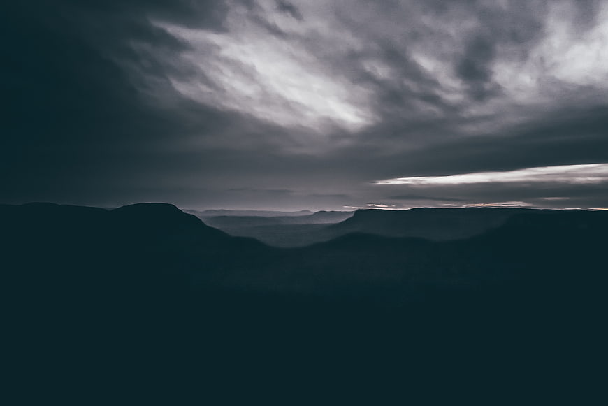 Dramatic dark mountain landscape under stormy clouds