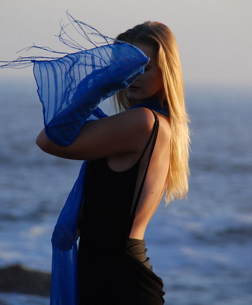 Woman with Blue Scarf by the Ocean