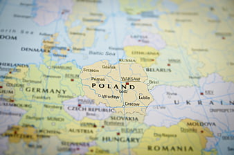 Close-up of a physical map highlighting Poland and Warsaw
