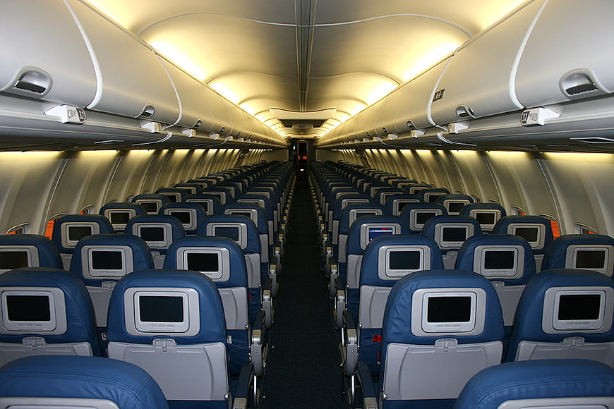 Empty Commercial Airplane Cabin Interior With Blue Seats