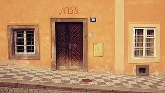 Old European Street with Orange Facade and Wooden Door