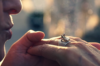 Close-up of a man's hand wearing a silver frog ring