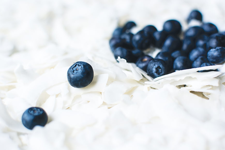 Fresh Blueberries on White Coconut Flakes