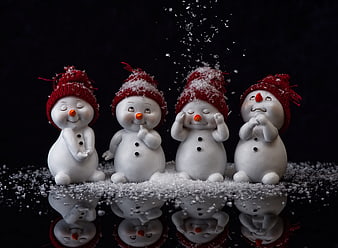Cute Snowman Figurines With Red Hats And Snow Reflection