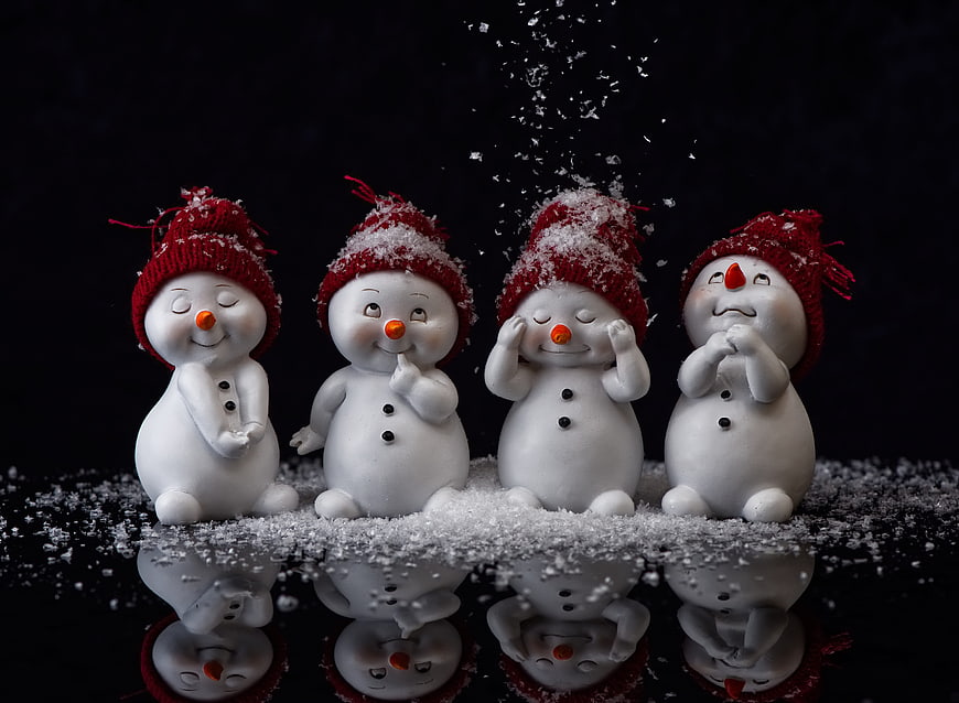 Cute Snowman Figurines With Red Hats And Snow Reflection