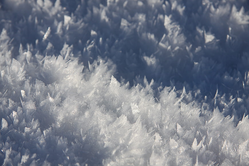 Macro close-up of intricate white ice crystals and frost patterns