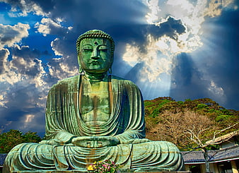 Large Green Buddha Statue Under Dramatic Cloudy Sky