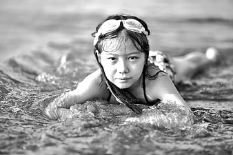 Black and White Portrait of Girl with Goggles in Ocean Waves