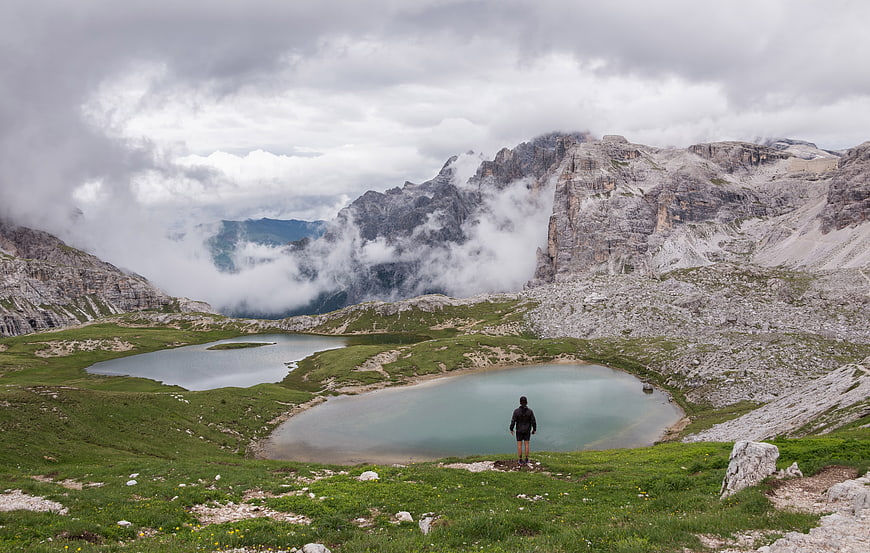 Lone Hiker Overlooking Alpine Lakes in Dolomites