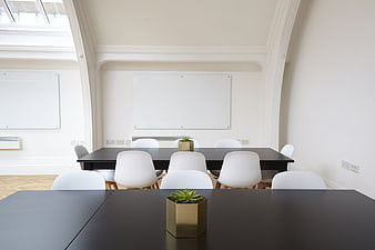 Minimalist Modern Office Meeting Room With White Chairs And Black Tables