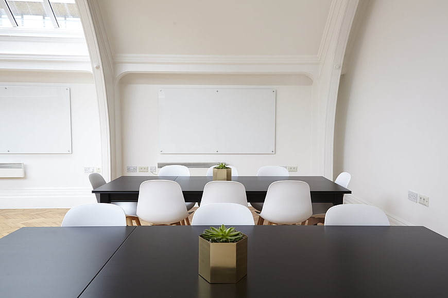Minimalist Modern Office Meeting Room With White Chairs And Black Tables
