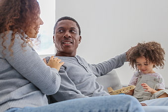 Happy African American Family Playing Together on Sofa