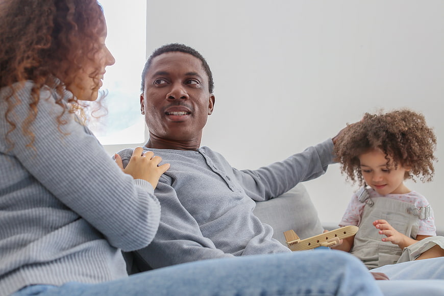 Happy African American Family Playing Together on Sofa