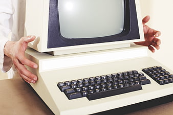 Hands Holding Vintage Retro Computer Monitor and Keyboard