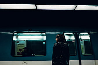Woman Waiting on Subway Platform at Night