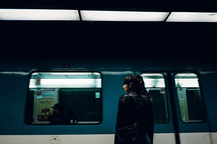 Woman Waiting on Subway Platform at Night