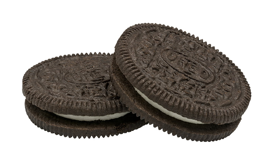 Two Chocolate Sandwich Cookies With White Cream Filling On White Background