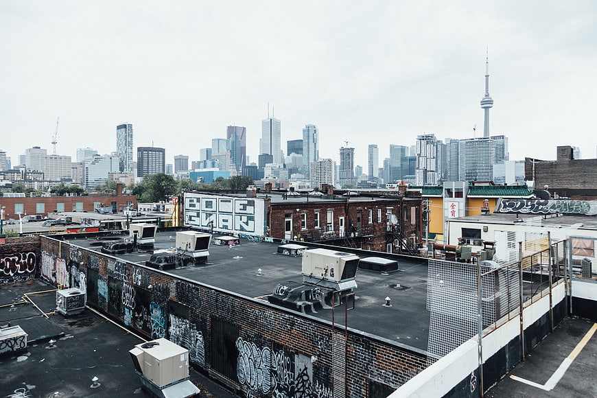 Toronto skyline view from graffiti-covered urban rooftop
