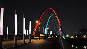 Illuminated Arch Bridge at Night with Colorful Lights