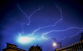 Dramatic Lightning Strike Over Residential Neighborhood at Night