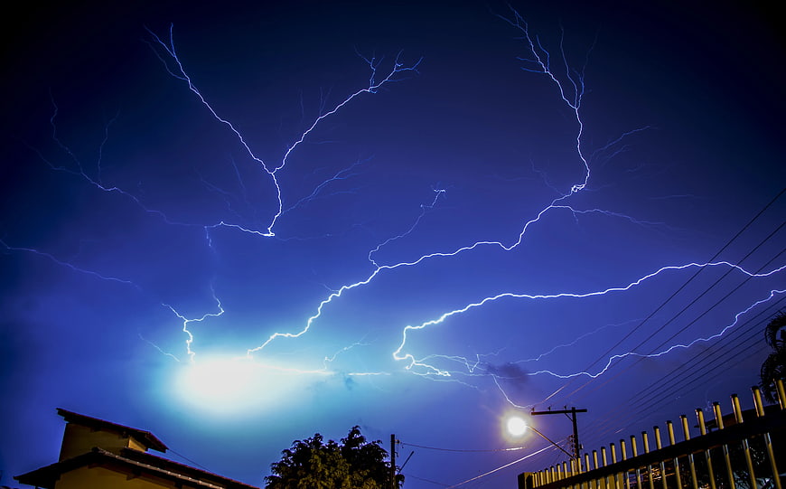 Dramatic Lightning Strike Over Residential Neighborhood at Night