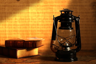 Vintage Lantern and Old Books on Antique Map