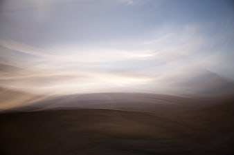Abstract blurred motion landscape of desert dunes and sky