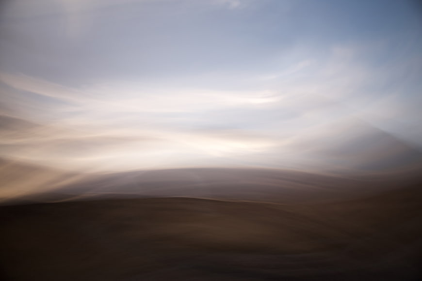 Abstract blurred motion landscape of desert dunes and sky