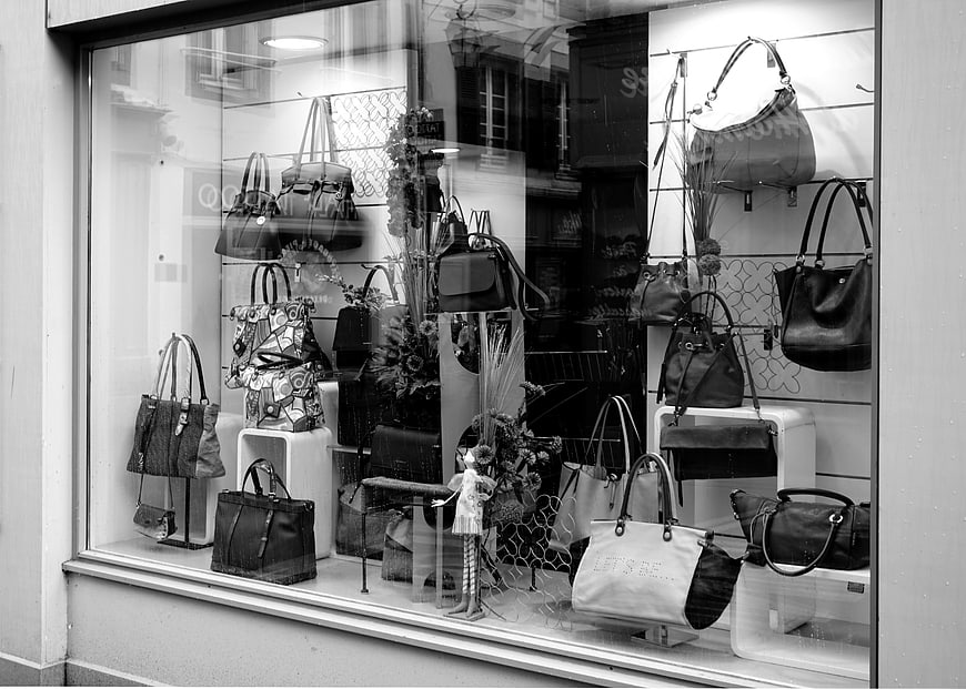 Black and white shop window display of handbags