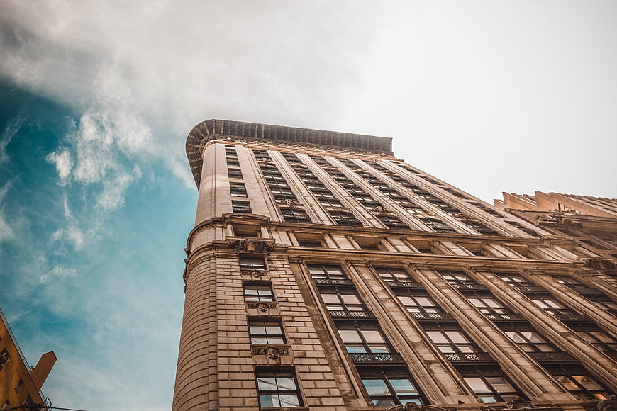 Low angle view of historic skyscraper against blue sky
