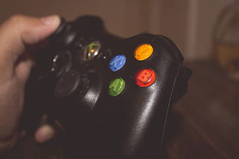 Close-up of Hand Holding Black Xbox Controller