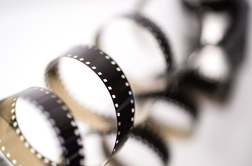 Close-up of vintage 8mm film strip on white background