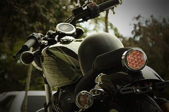 Close-up of black motorcycle rear with red taillight