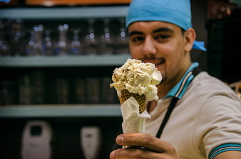 G gelato man holding ice cream cone
