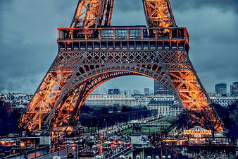 Eiffel Tower at Dusk with Golden Lights and Paris Skyline