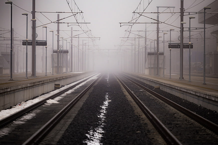 Foggy Train Tracks at Empty Railway Station