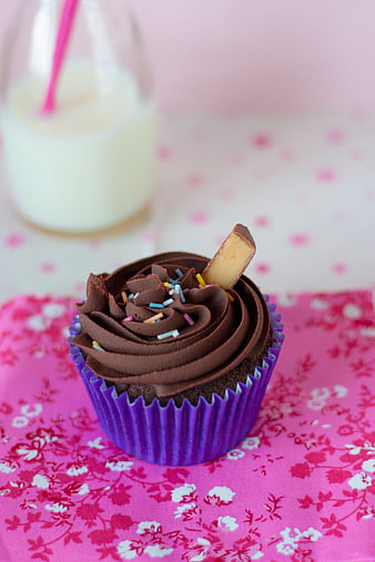 Chocolate cupcake with milk in a pink floral setting