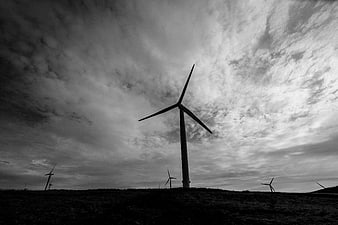 Black and White Wind Turbine Silhouette Against Dramatic Cloudy Sky