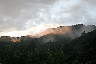 Misty Mountain Landscape with Golden Hour Sunlight