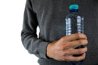 Man holding plastic water bottle against white background