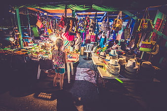 Colorful Night Market Stall with Hats and Bags