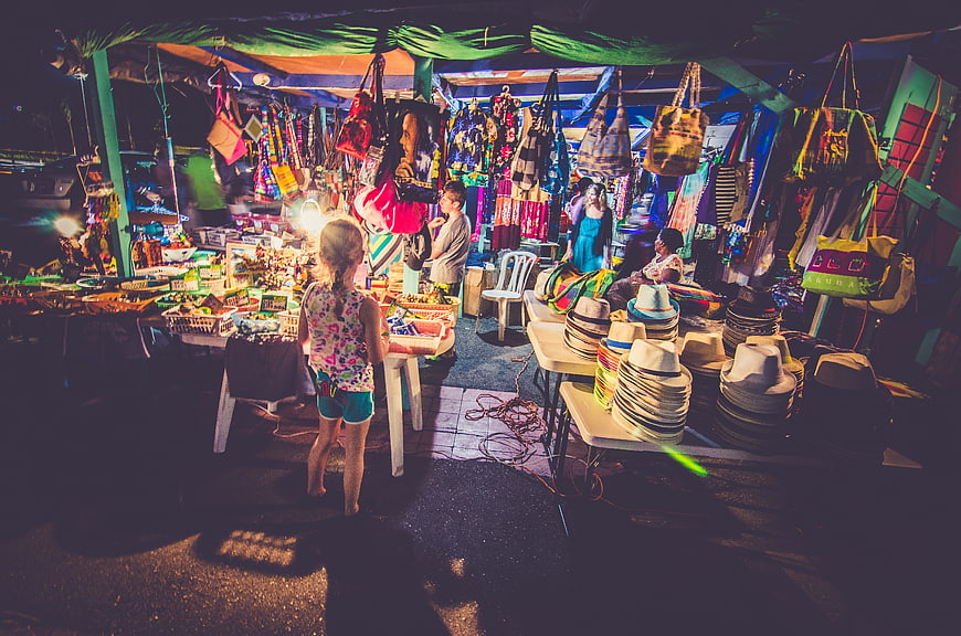 Colorful Night Market Stall with Hats and Bags
